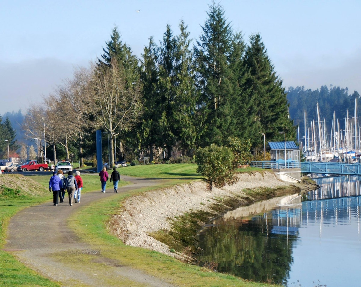People walk along the Peninsula Walk toward Billy Frank Jr. Park at the Port of Olympia